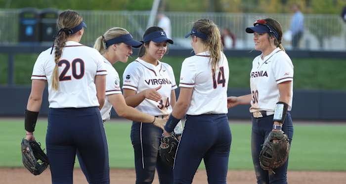 Eden Bigham celebrates with her teammates in the pitcher's circle during the Virginia softball game against JMU at Palmer Park.